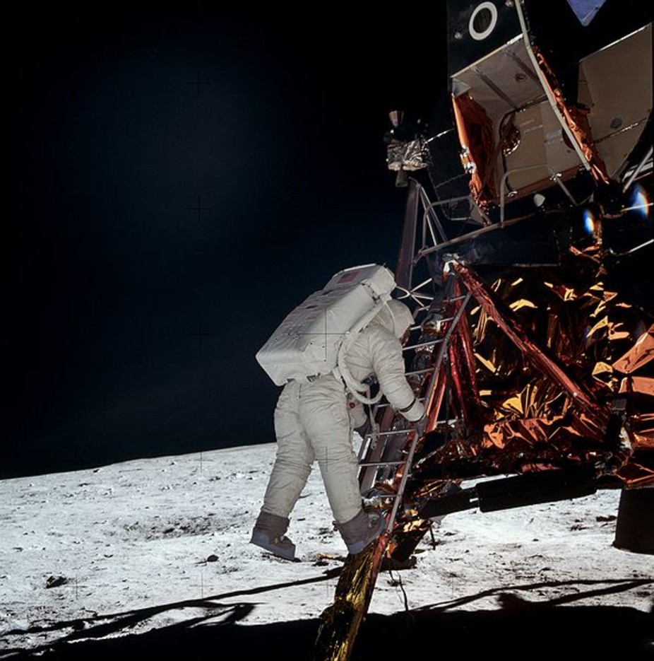 Neil Armstrong steps from the LEM
